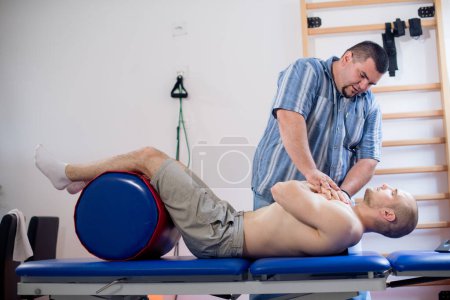 Physio therapist doing exercise for chest spine