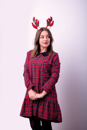 Attractive young woman with horn of reindeer on her head