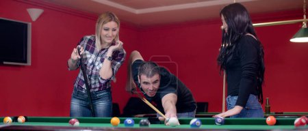 Friends are playing billiard