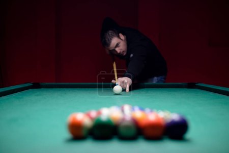 Photo for Attractive young man is playing billiard - Royalty Free Image