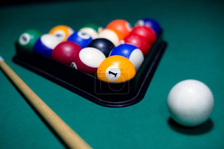 Close up of a balls and stick on a pool table