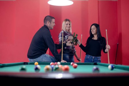 People are enjoying in game of pool