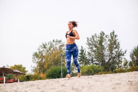 Photo for Vital woman running on the beach. - Royalty Free Image