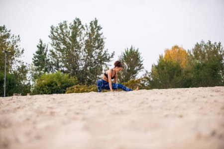 Athlete doing morning exercises on the beach.