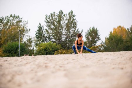 Photo for Young beautiful woman having sports training on the beach. - Royalty Free Image