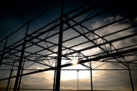 Steel construction in shadows, in front of blue sky