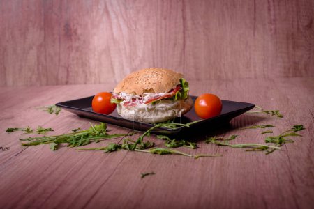 Sandwich with cherry tomatoes nicely decorated on a wooden table