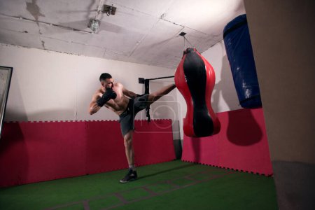 Photo for Young man kickboxing workout - Royalty Free Image