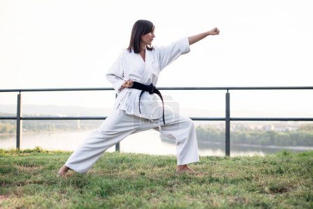 Woman in kimono practicing karate.