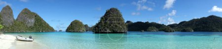 Téléchargez les photos : Panorama des îles rocheuses de Wayag Indonésie Raja Ampat avec Dinghi sur la plage. Photo de haute qualité - en image libre de droit