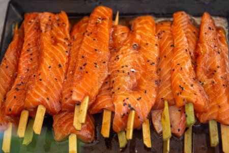 Photo for Marinated salmon on a stick ready to be cooked - Royalty Free Image