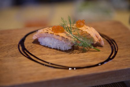 Photo for Fresh seared salmon with ikura and eel sauce served - Royalty Free Image