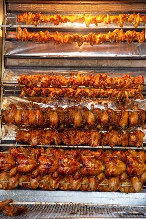 Photo for Racks of Chicken Roasting at a market - Royalty Free Image
