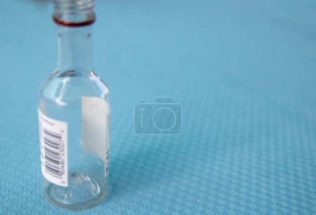 Photo for An empty alcohol bottle on a table - Royalty Free Image