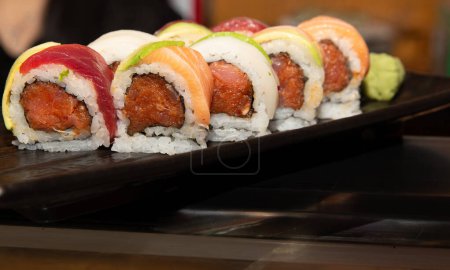 Photo for Spicy Tuna Roll topped with various seafood - Royalty Free Image