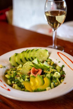 Photo for Avocado Salad served with White Wine - Royalty Free Image