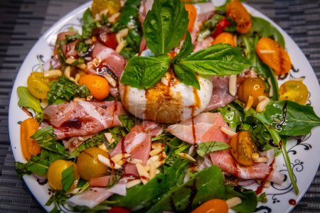 Photo for Fresh burrata on a salad with procuitto - Royalty Free Image