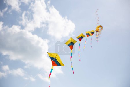 Colorful Kites in Sync Flying at a festival