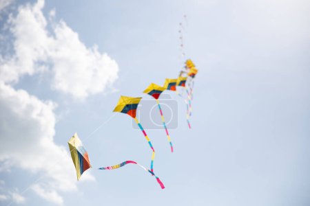 Colorful Kites in Sync Flying at a festival