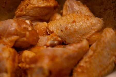 Seasoned raw chicken wings to be fried