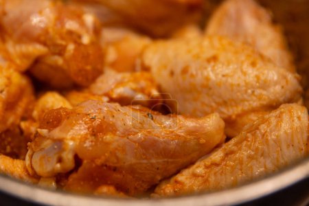 Seasoned raw chicken wings to be fried