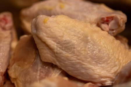 Unseasoned raw chicken wings to be fried