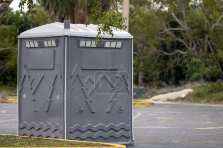 Photo for Single Big Port a Potty in a parking lot - Royalty Free Image