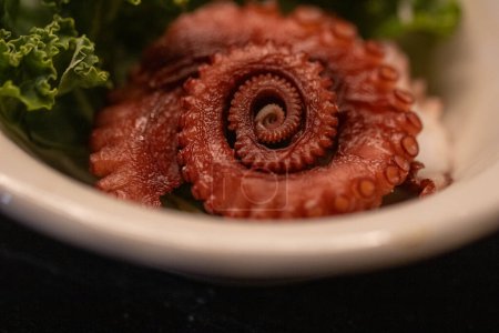 Octopus  tentacle Sashimi Served in a ramekin