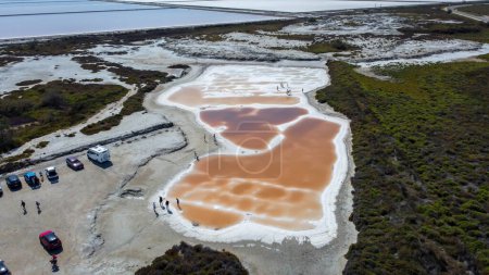 pools of red water rich in salt, tourist attraction of the Giraud salt pans in the Camargue regional natural park in Provence. bright colors captured by a drone. very salty water visited by tourists in summer. Natural landscape of the salt marshes