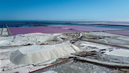 Photo for Amazing salt mountain, salt deposit of the Saline de Giraud in Provence in the Camargue Regional Natural Park France. wonders of the Mediterranean and Provence on sunny day. tourist half for a trip. natural aerial photo captures big mountain of salt - Royalty Free Image
