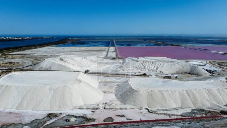 Amazing salt mountain, salt deposit of the Saline de Giraud in Provence in the Camargue Regional Natural Park France. wonders of the Mediterranean and Provence on sunny day. tourist half for a trip. natural aerial photo captures big mountain of salt