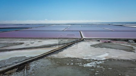 endless expanses of salt reserves in the salin de Giraud in the Camargue regional natural park in Provence at the mouth of the Rhone. Bright colors on a sunny summer day. natural landscape of France. Magnificent colors taken from above by a drone