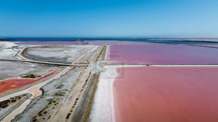 endless expanses of salt reserves in the salin de Giraud in the Camargue regional natural park in Provence at the mouth of the Rhone. Bright colors on a sunny summer day. natural landscape of France. Magnificent colors taken from above by a drone