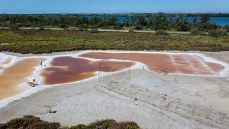 pools of red water rich in salt, tourist attraction of the Giraud salt pans in the Camargue regional natural park in Provence. bright colors captured by a drone. very salty water visited by tourists in summer. Natural landscape of the salt marshes