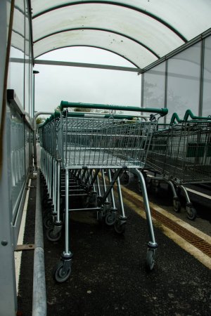 Shopping trolly's lined up at a supermarket. Side on view.