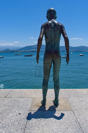 Photo for Santander Spain. June 28th 2022.  Statue monument to Los Raqueros, Santander, Spain. Bronze boy figurines playfully situated at the waters edge. Tourist attraction. copy space. - Royalty Free Image