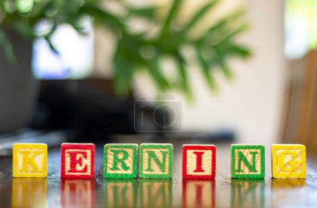 Photo for Kerning word written with deliberate uneven spacing between the letters to display bad kerning. Typo and grammar image. Selective focus on the letters. - Royalty Free Image