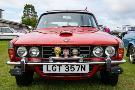 Photo for Exmouth, Devon, uk. 08-13-23. Rover P6 V8 classic car. 3500cc engine. Close up picture of the chrome front grill with classic badges displayed. Selective focus on the Rover badge on the bonnet. - Royalty Free Image