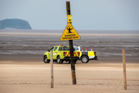 Photo for Danger sinking mud sign. Selective focus on the yellow sign. Quicksand. - Royalty Free Image