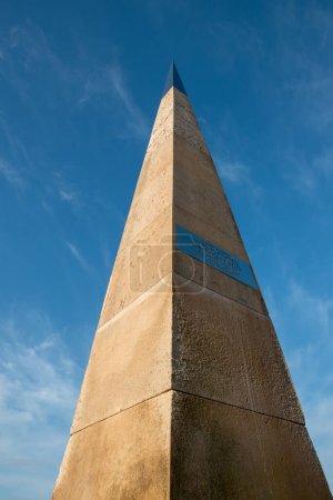 Photo for Exmouth, Devon, uk. April 25th 2023. Exmouth Geoneedle looking up from a low vantage point.  Situated on Orcombe point. Selective focus on the Metal plate on the geoneedle. - Royalty Free Image