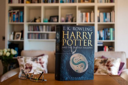 Photo for Ideford, Devon, uk. April 15th 2023. Harry Potter and the Deathly hallows, by J K Rowling. Dark cover edition. Set against a softly focused bookcase background. Selective focus on the front cover - Royalty Free Image