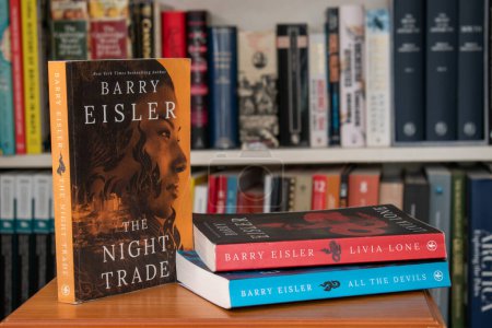 Photo for Churston, Devon, UK. December 17th 2022. The night trade, a Livia Lone novel by Barry Eisler. Selective focus on the E of Eisler on the front cover. The first book in a series of exceptional thrillers - Royalty Free Image