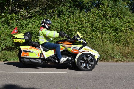 Photo for Powderham, Devon, uk. July 9th 2022.  Can-Am Spyder F3 three wheeled motorcycle, Devon Freewheelers rapid blood delivery bike. Hi visibility dayglo yellow and orange. Advanced motorcycle rider - Royalty Free Image