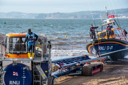 Photo for Exmouth, Devon, uk. 02-15-24. RNLI Lifeboat crew prepares to retrieve a Shannon class lifeboat at Exmouth lifeboat station. Sea safety life saving image. Copy space. - Royalty Free Image