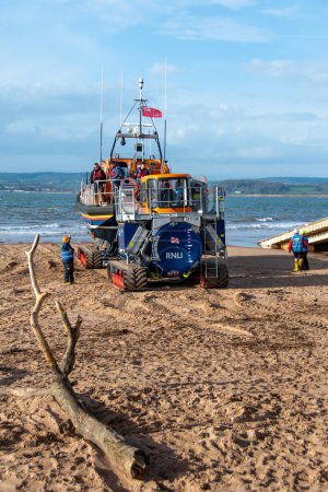 Photo for Exmouth, Devon, uk. 02-15-24. RNLI Lifeboat crew prepares to launch a Shannon class lifeboat from Exmouth lifeboat station. Sea safety life saving image. Copy space. Portrait format. - Royalty Free Image