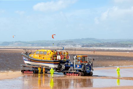 Photo for Exmouth, Devon, uk. 04-07-24. RNLI Lifeboat crew launch a Shannon class lifeboat from Exmouth beach. - Royalty Free Image