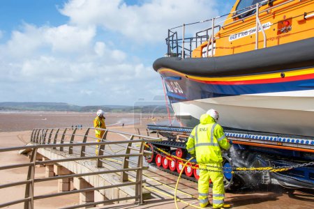Photo for Exmouth, Devon, uk. 04-07-24. RNLI Lifeboat crew wash down a Shannon class lifeboat after it's return to Exmouth lifeboat station. - Royalty Free Image