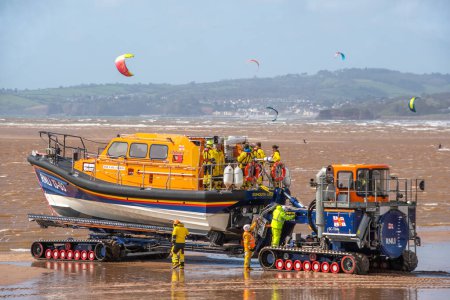 Photo for Exmouth, Devon, uk. 04-07-24. RNLI Lifeboat crew launch a Shannon class lifeboat from Exmouth beach. - Royalty Free Image