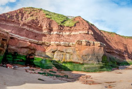 Jurassic strata in cliffs between Exmouth and Budleigh Salterton. Sandstone with clearly visible layers. Geology and fossils. Orcombe point at a world heritage site. 