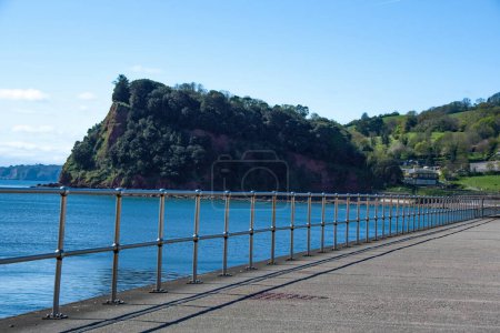 Photo for Teignmouth, Devon, uk. 04-20-24. Teignmouth seafront panorama picture looking towards the Ness in Shaldon. - Royalty Free Image